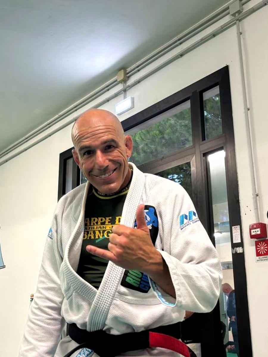 Roberto Atalla smiling in a gi at Rio Grappling Club Summer Camp in Cesenatico, Italy, 2025